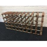 A wood wine rack by Farrow & Jackson Ltd, the compartments for forty bottles.