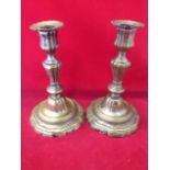 A pair of Georgian silver plated candlesticks, the fluted baluster columns on circular scalloped