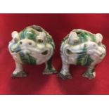 A pair of Chinese stoneware toad spoonwarmers, the three legged beasts with open backs