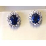 A pair of boxed sapphire & diamond cluster earrings, the oval sapphires of over two-and-a half