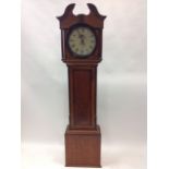 A Victorian oak longcase clock, with moulded swan-neck pediment above circular glazed door