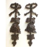 A pair of nineteenth century walnut European wall sconces carved with vines and leaves from ribbon