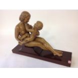 D Daniel, a carved mother & child, the 1930s terracotta figures on rectangular mahogany plinth