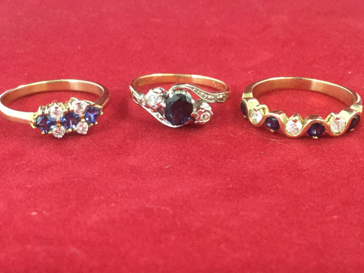 Three 18 carat gold diamond and sapphire rings, the bands claw set with contrasting stones. (3) - Image 2 of 3