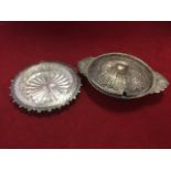 An unusual silver dish with glass liner, the rim with punched decoration within a scalloped engraved