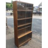 A glazed oak Minty of Oxford bookcase, in five graduated sections, each with sliding glass doors