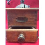 An oak coffee grinder, with crank handle above a domed enclosure, the dovetailed case with knobbed