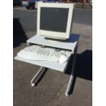 A Mitsubishi computer monitor with Microsoft keyboard and mouse, complete with computer table on