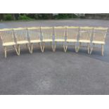 A set of eight spindleback chairs, with saddle shaped seats on turned legs & stretchers. (8)