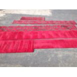 A quantity of stair carpet or runners in the Turkish pattern woven on red ground; and other