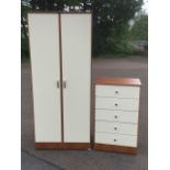 A 70s wardrobe and chest of drawers, with laminated panels framed by teak trim, the chest with