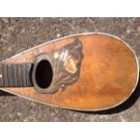 A small nineteenth century German mandolin, inlaid with floral marquetry decoration around oval