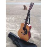 A Martin Smith steel string guitar, with ebonised fingerboard and cedar soundboard, complete with