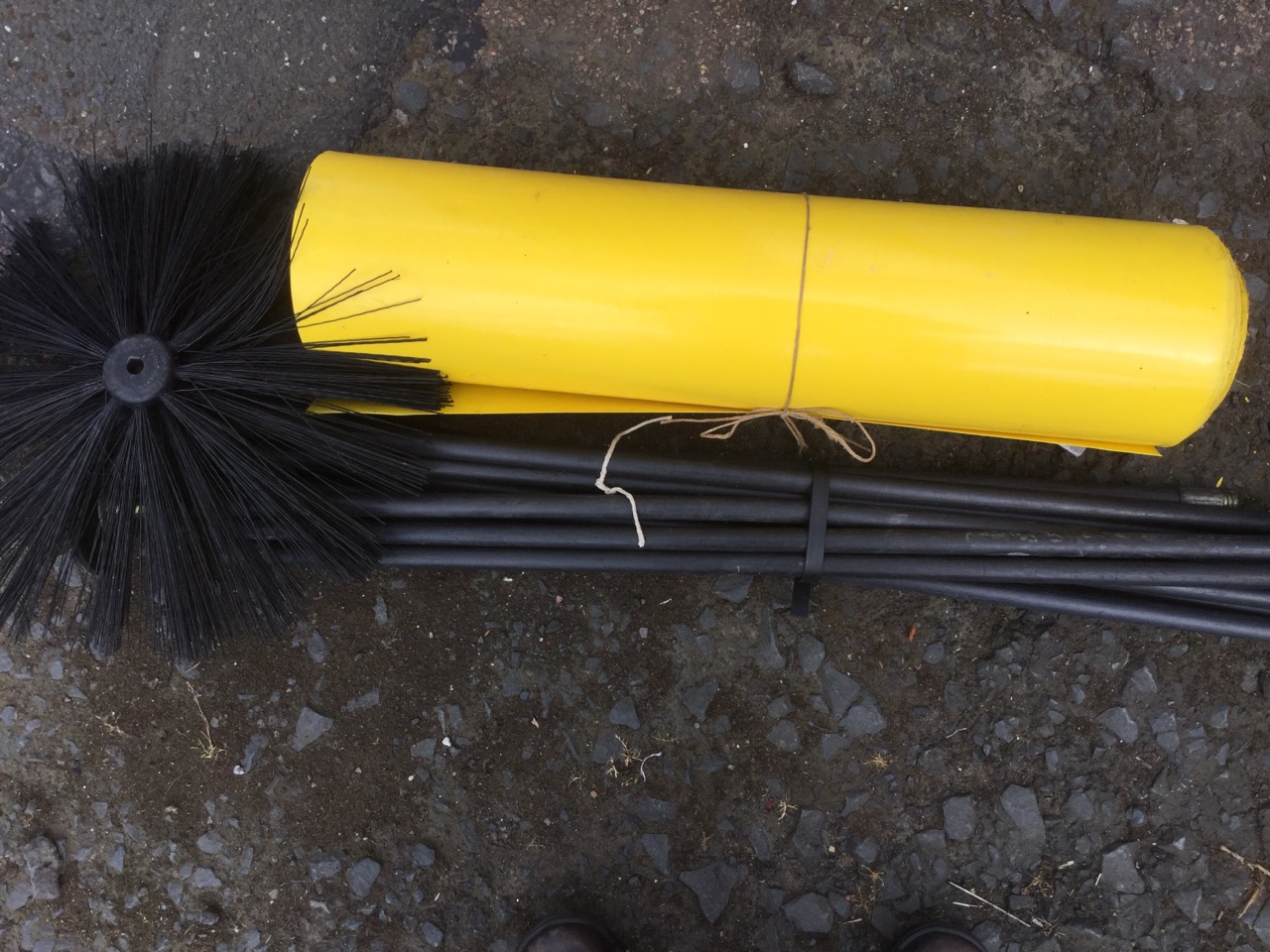 A set of flexible draining or chimney rods; and a roll of garden plastic. (2)