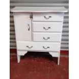 A small painted cabinet with serpentine shaped top above a cupboard flanked by three small