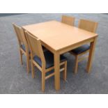 A modern dining table & chair set with square decorative panels, the table with rectangular top