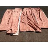 A suite of four pink striped lined curtains. (4)