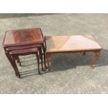 A nest of mahogany tables with plate glass to tops, the shaped carved scalloped frames supported