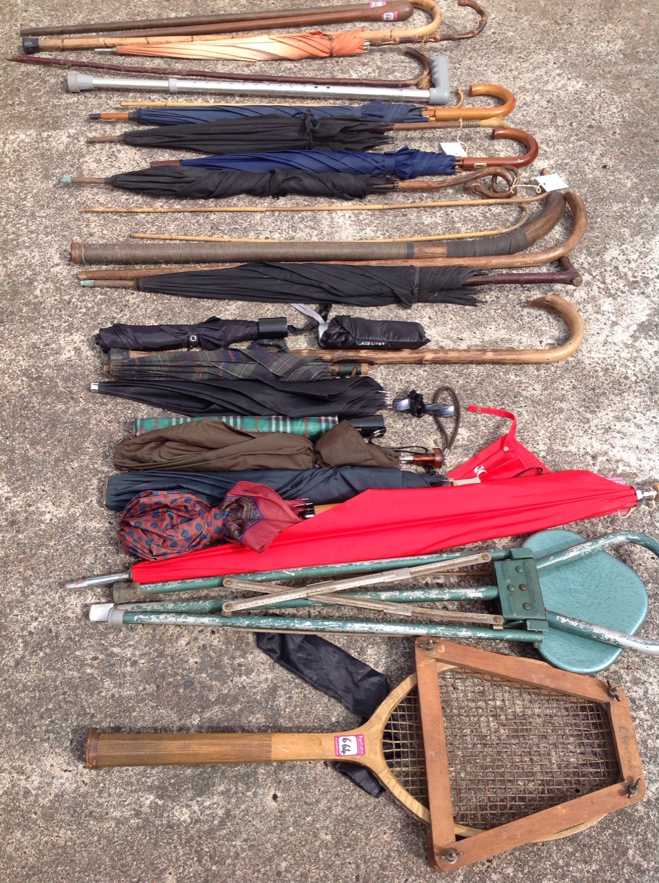 A quantity of walking sticks & umbrellas including ladies, a shooting stick, a vintage tennis racket