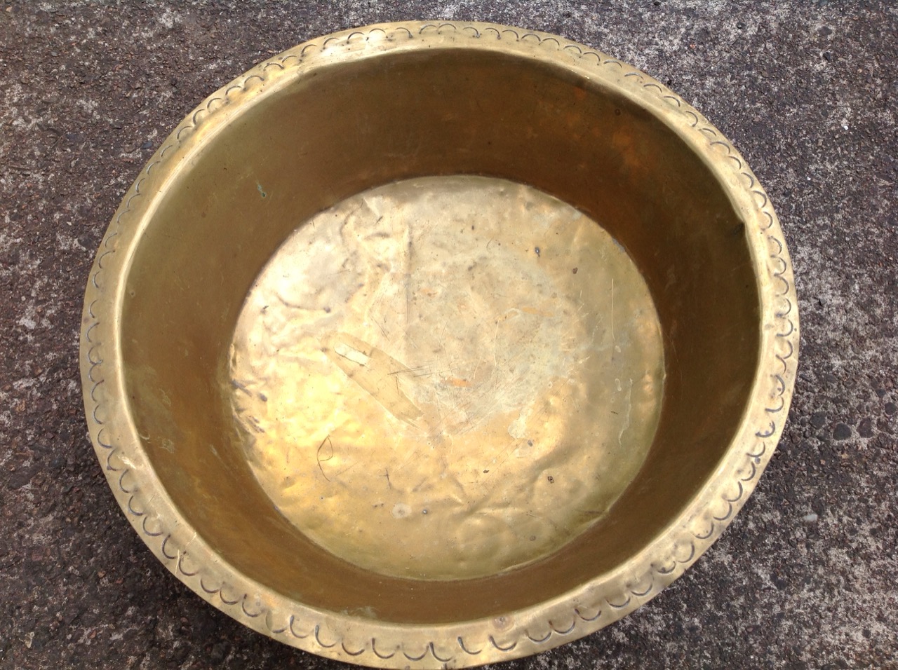 A circular brass bowl, the flat rim with hammered crescent decoration. - Image 3 of 3