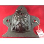 A nineteenth century cast iron wall fountain with lionhead on shaped backplate cast with the
