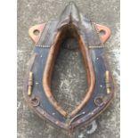 A large leather horse collar, the wood frame with iron mounts and rings with brass studding,