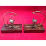 A pair of Edwardian bronze & coramondel bookends, cast as cats beneath ormolu crescent moons,