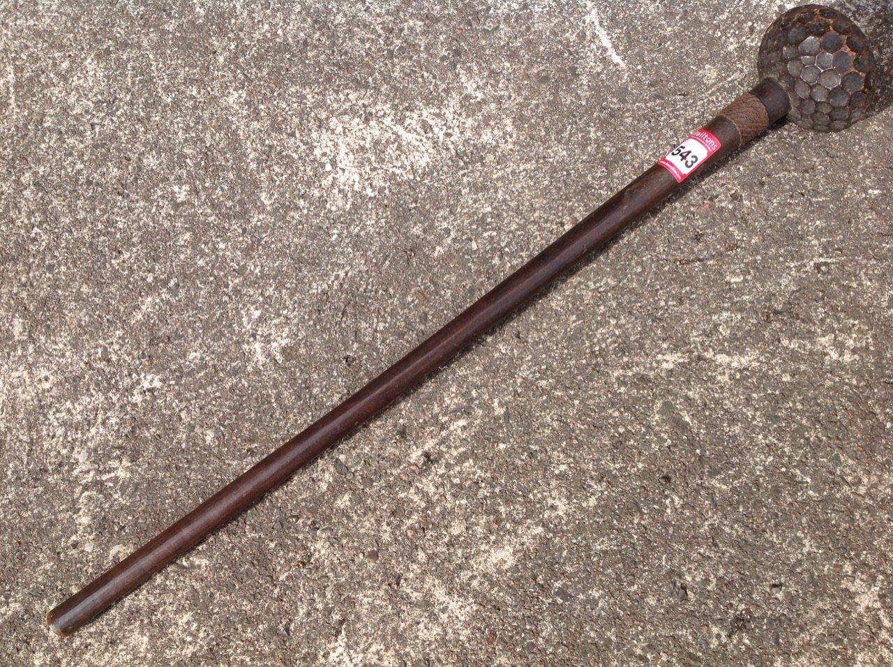 A nineteenth century knobkerrie carved out of the solid, the tapering shaft mounted with wirework