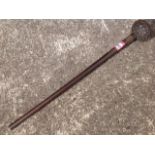 A nineteenth century knobkerrie carved out of the solid, the tapering shaft mounted with wirework