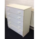 A modern white laminated chest of five drawers.