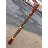 An Australian didgeridoo, the tapering woodwind instrument with snake & turtle like enamelled and