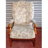 A modern upholstered armchair, with button back and sprung seat, raised on rectangular tapering