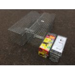 A pair of rectangular rabbit traps with drop-down doors; and a pair of Big Cheese rat cage traps. (