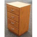 A chest of four drawers mounted with chrome handles.