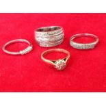 Four miscellaneous gold rings, all set with diamonds. (4)