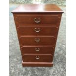 A mahogany chest of five graduated panelled drawers mounted with brass scrolled handles, supported