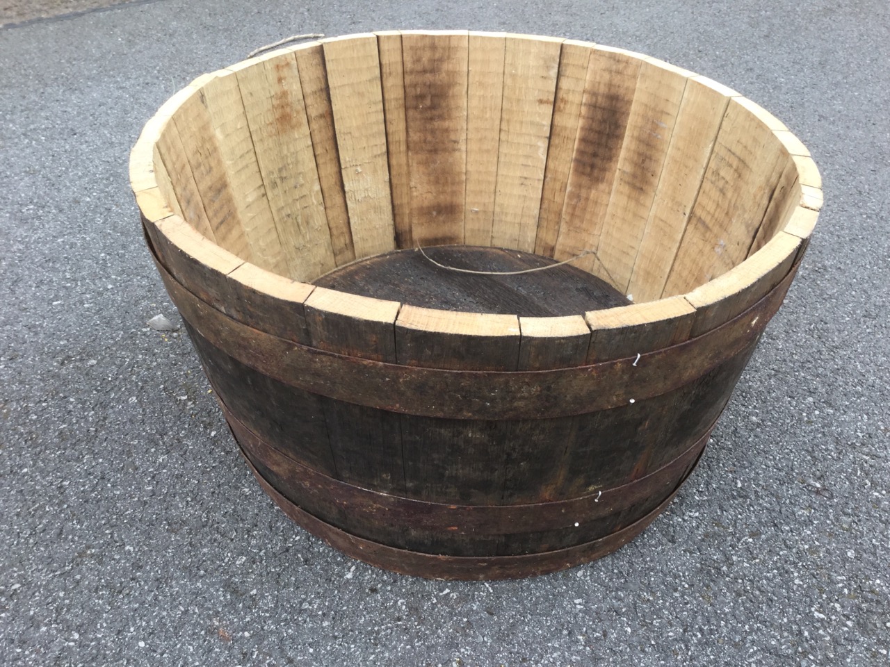 An oak barrel planter, the tub with three metal bands binding staves. - Image 2 of 3