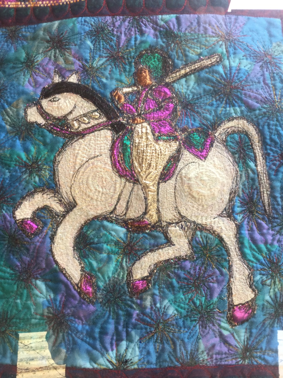 A large framed embroidered and quilted tapestry depicting a horse & rider, with leaf border. - Image 2 of 3