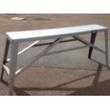 A steel Draper workbench with rectangular top raised on angled tapering legs.