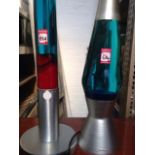 A Mathmos vase shaped glass lava lamp on spun aluminium stand; and another of tall tubular form -