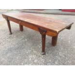 A rectangular pine bench, the seat with plain apron supported on turned legs with pad feet.