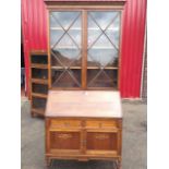 An oak bureau bookcase, the top with moulded cornice above astragal glazed doors enclosing