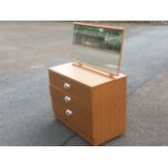 A teak style dressing table, with three drawers to chest beneath an angled rectangular mirror on