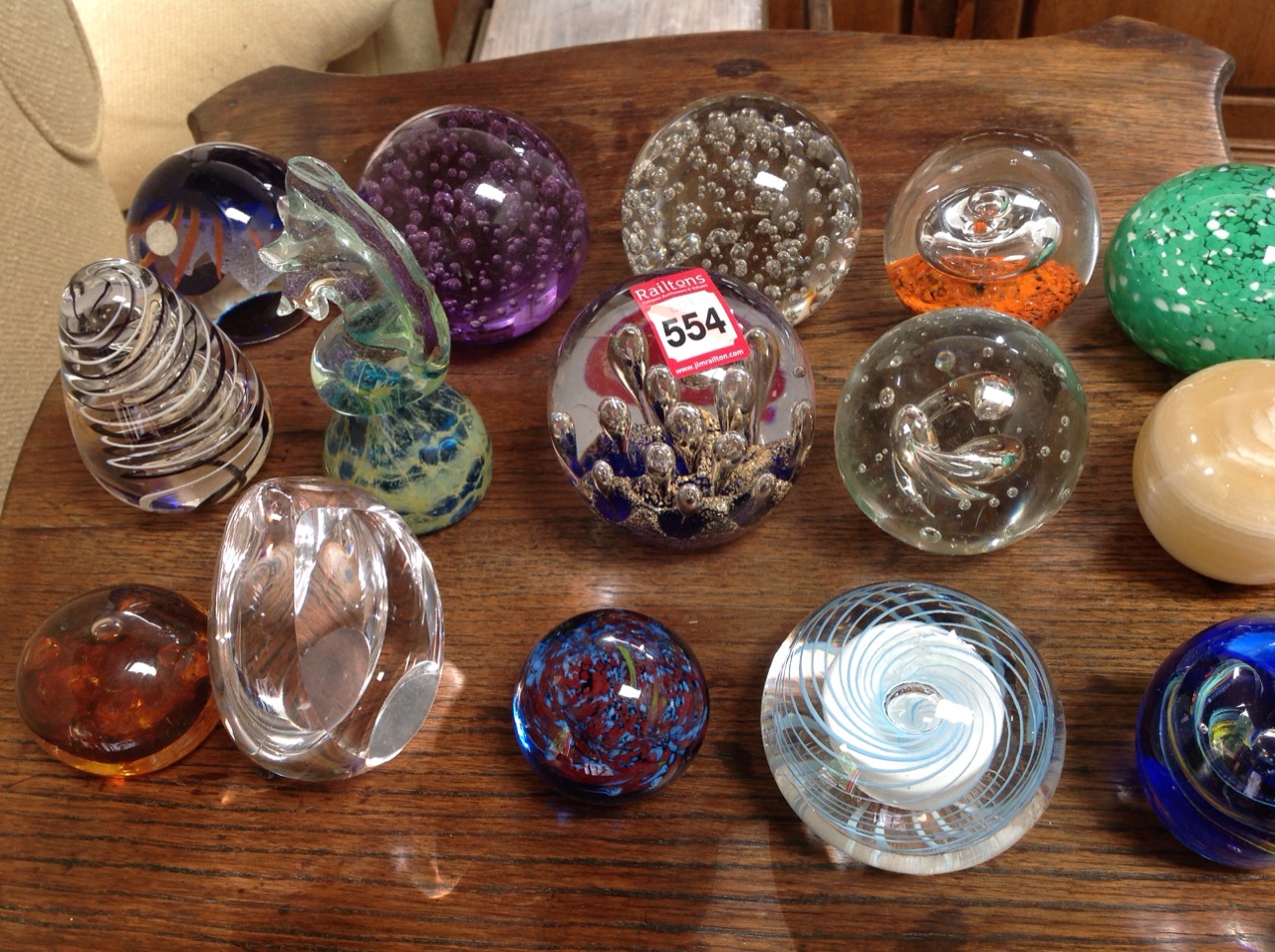 A collection of glass paperweights - Langham, Mdina, amber coloured, marbled, swirling, bubbled,