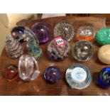 A collection of glass paperweights - Langham, Mdina, amber coloured, marbled, swirling, bubbled,