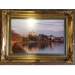 A large gilt framed view of Warkworth Castle from the river.