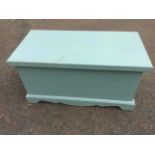 A painted blanket box of dovetailed construction, raised on moulded plinth.