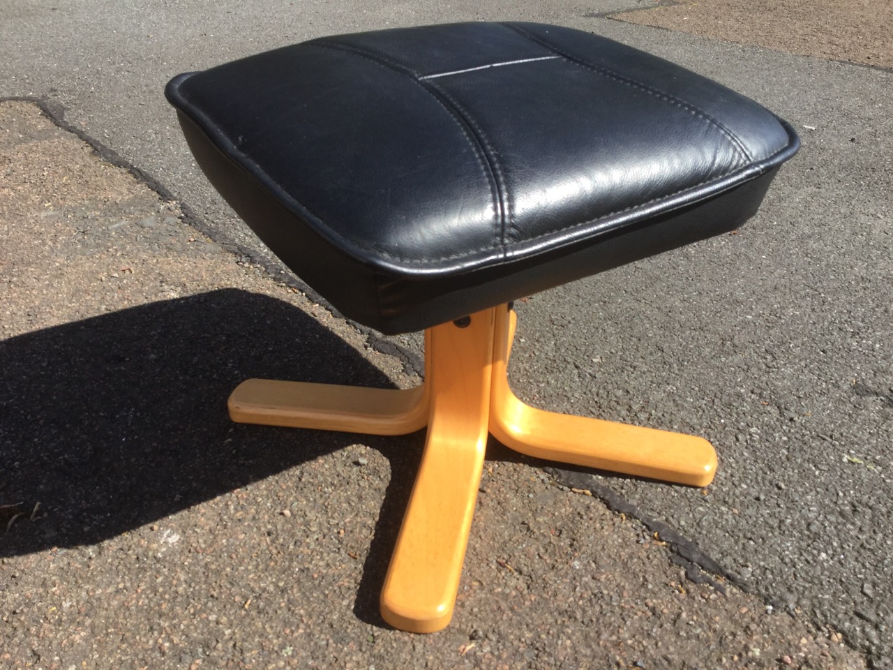 A modern leather upholstered armchair and footstool, with panelled back, seat and arms, supported on - Image 2 of 3