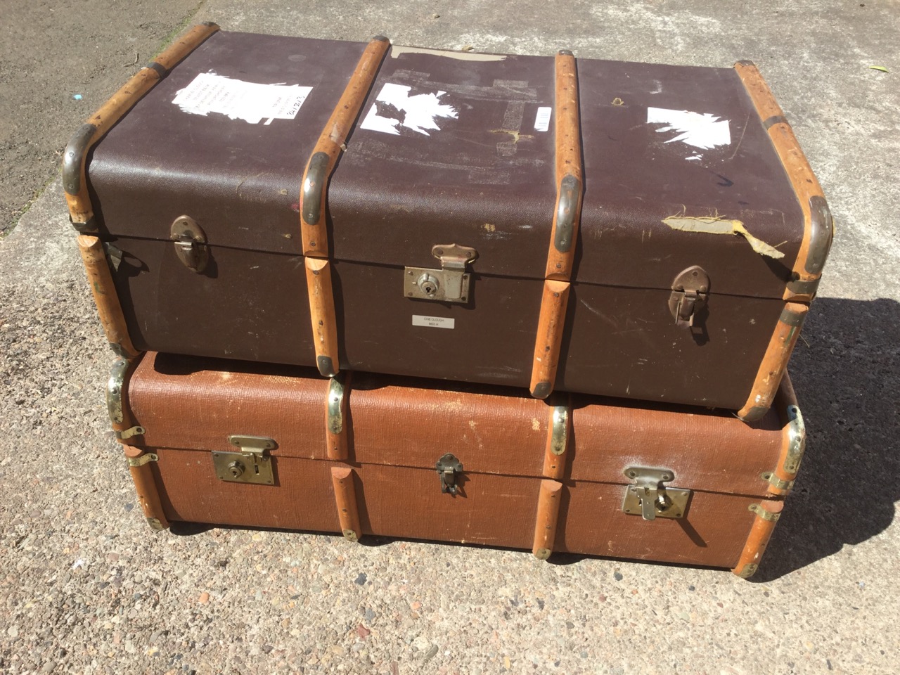 A rectangular school trunk with wood slats, brass mounts and leather handles to hessian covered