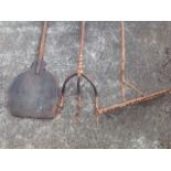 Three rural farm implements - a three pronged fork formed from one branch, a two-way rake with stick